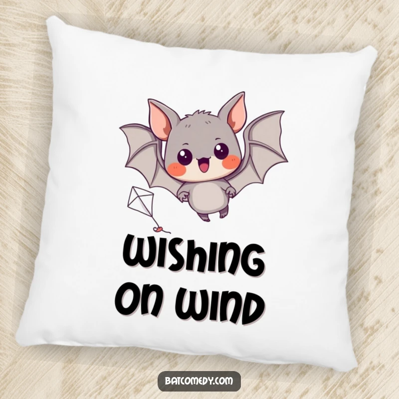 Funny pillow featuring a black bat with excited eyes, trying to fly a miniature kite.