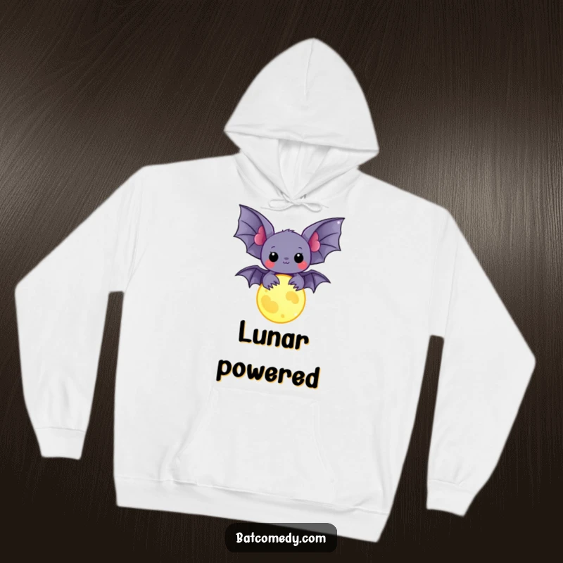 Funny kawaii bat holding a glowing moon charm, bringing a sense of wonder and humor to a cozy hoodie.
