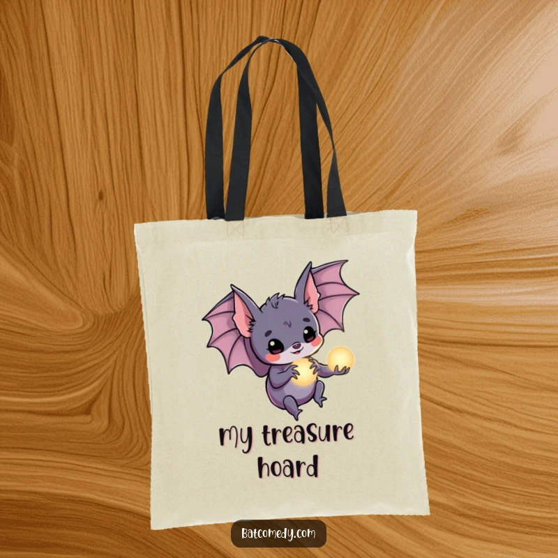 Funny bat tote bag displaying a bat holding a small, glowing orb in its claws, perfect for carrying magical treasures.